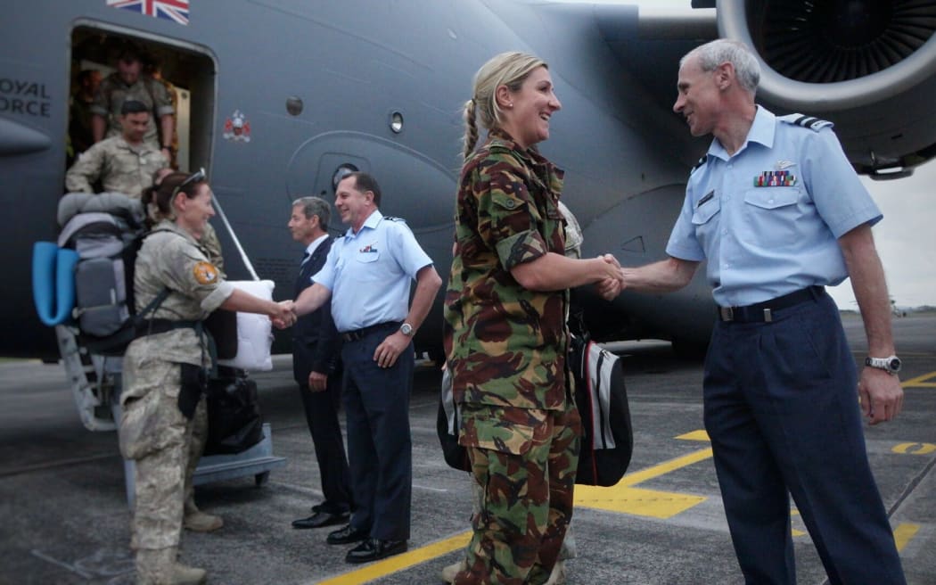 Personnel being welcomed back to New Zealand after stepping off the plane.
