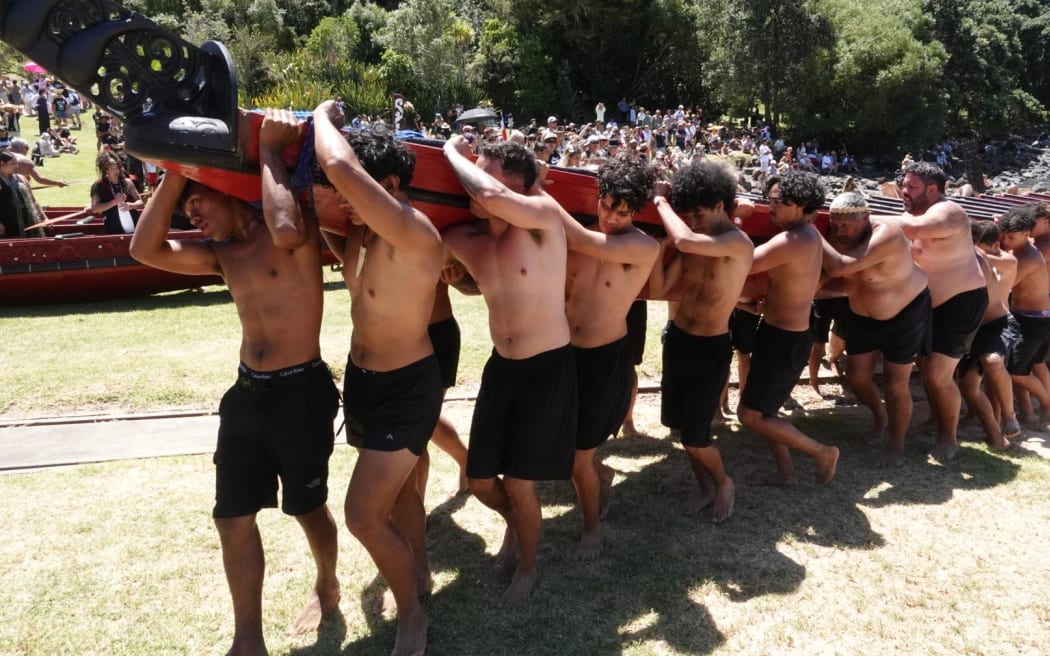 A waka is carried out of the water.