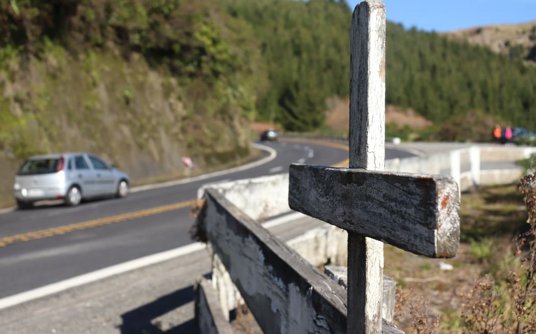 A cross stands on State Highway 5, marking the spot of a fatal crash on the road