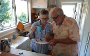 Kerikeri retirees John Logie and Lyn Bellinger, of Kerikeri, study their latest power bill.