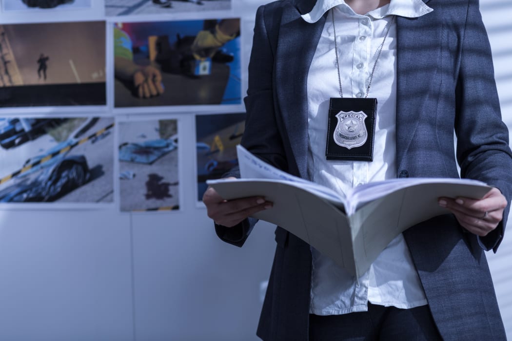 Police woman is reviewing files and documents.