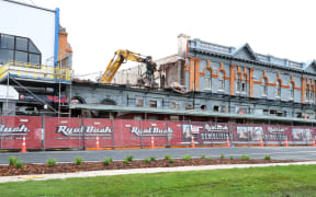 An image of Royal Bush Demolition taking down the east end of the frontage of the Club Hotel, on Bluffs main street, on Friday. The building has been closed due to earthquake risk and needed to be removed for the Bluff Oyster & Food festival to go ahead.