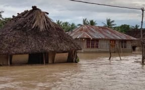 This general view shows homes surrounded by floodwaters in the village of Haitimuk in East Flores on April 4, 2021, after flash floods and landslides swept eastern Indonesia and neighbouring East Timor.