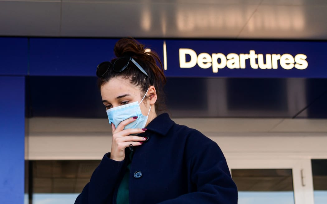 A passenger wearing a protective face mask in Linate Airport in Milan.
