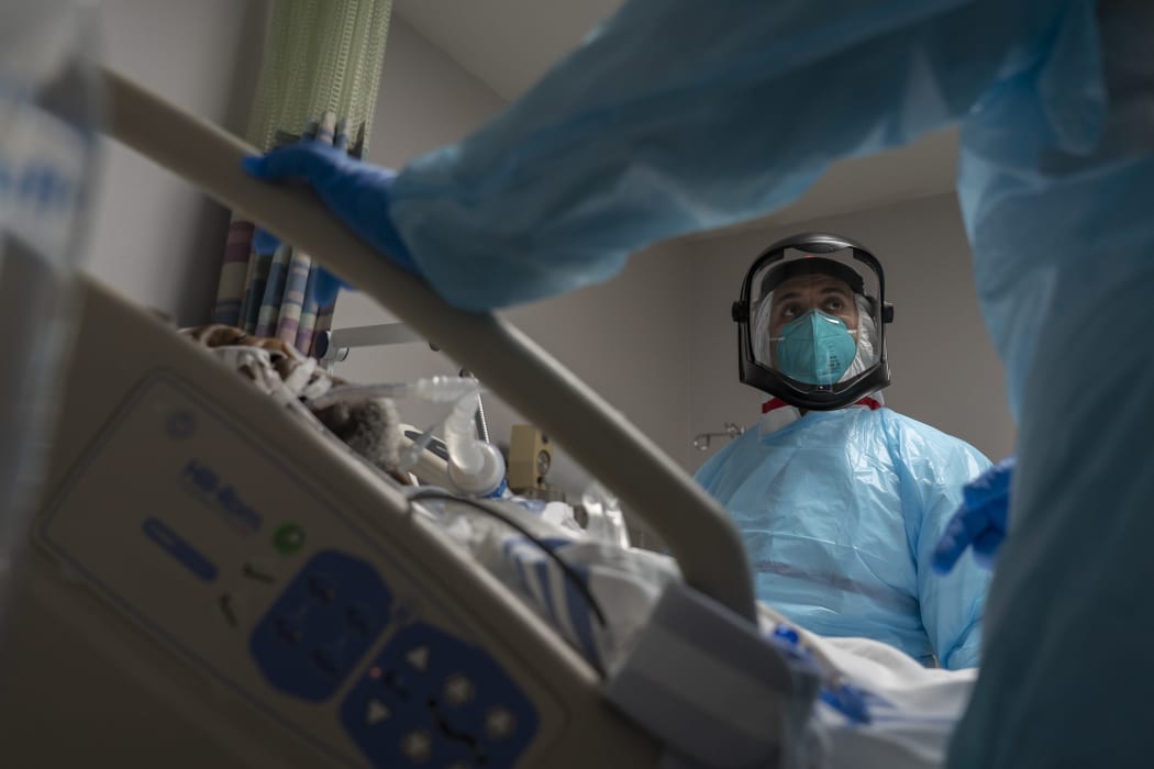 Medical staff treat a patient in the Covid-19 intensive care unit on New Year's Eve at the United Memorial Medical Center in Texas