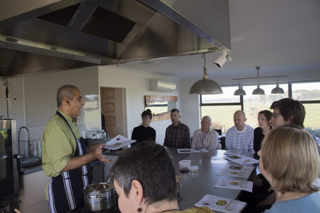 Gautam breaks down the dishes he is about to cook for the class.