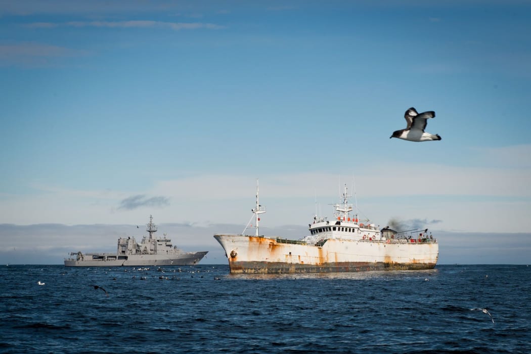 HMNZS Wellington (L) gathering evidence of illegal fishing in Antarctic waters.