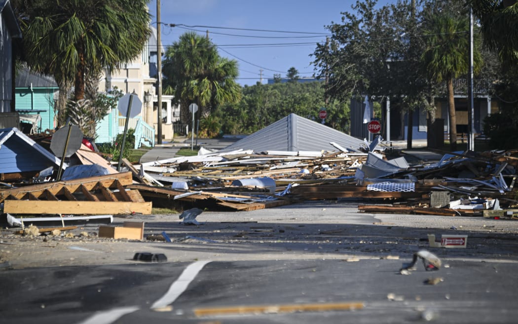 Debris left by Hurricane Helene after making landfall are seen in Cedar Key, Florida, on September 27, 2024. Hurricane Helene weakened on September 27 hours after it made landfall in the US state of Florida, with officials warning the storm remained "extremely dangerous" as it surged inland, leaving flooded roads and homes in its wake.