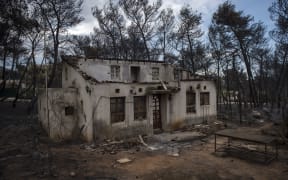 A photo shows a burned house following a wildfire at the village of Neos Voutzas, near Athens, on July 24, 2018.