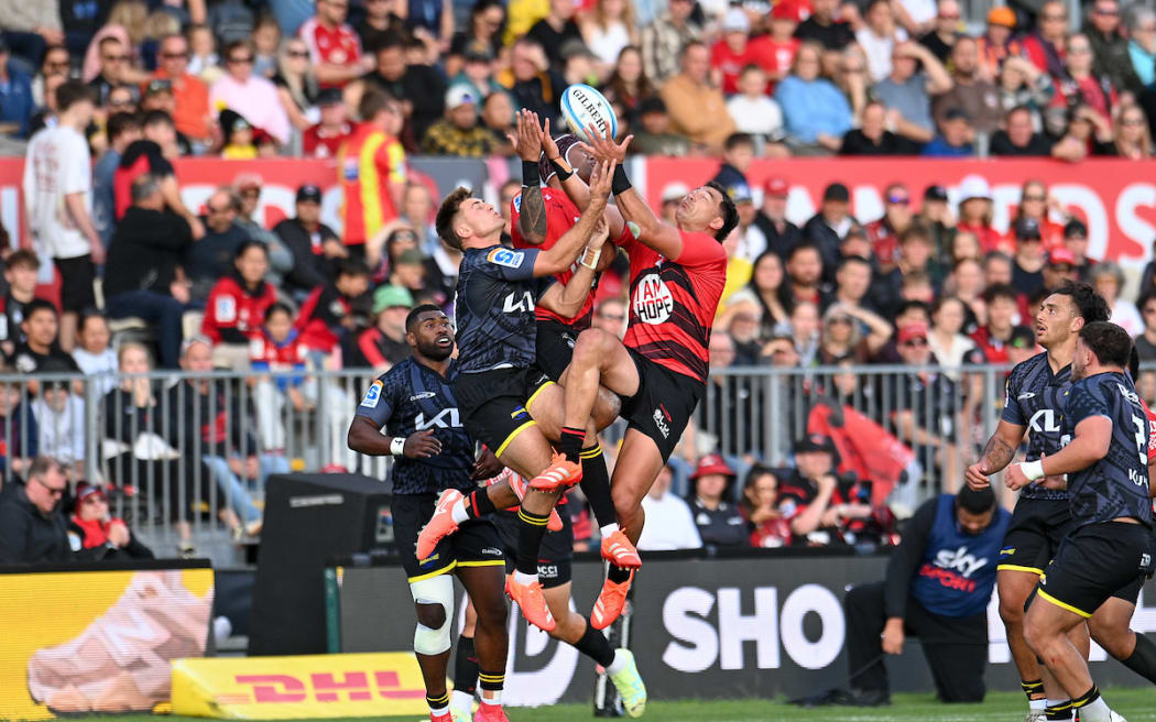Harry Godfrey and Chay Fihaki go for a high ball during the Super Rugby Pacific - Crusaders v Hurricanes at Apollo Projects Stadium, Christchurch.
