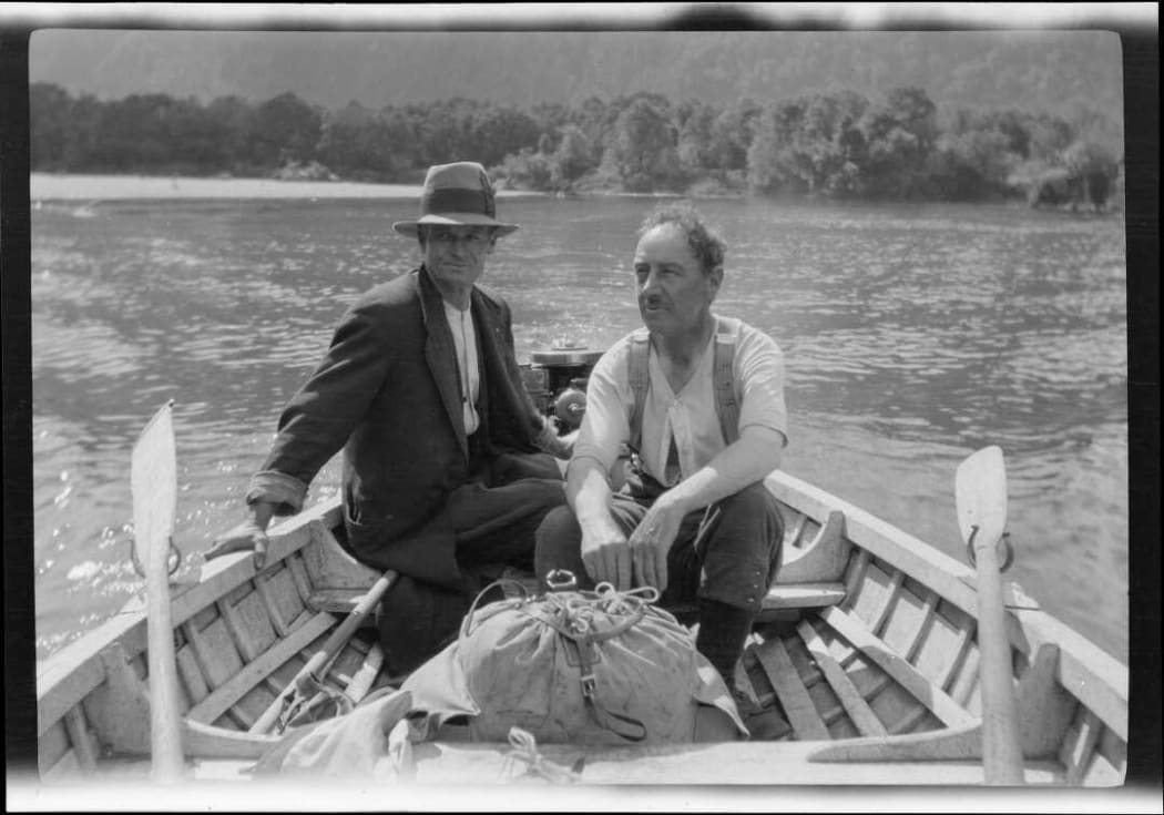 Archive photo of two men in a rowboat, taken 1922.
