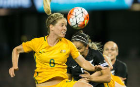 Australian Matildas player Elise Kellond-Knight goes up to head the ball against New Zealand.