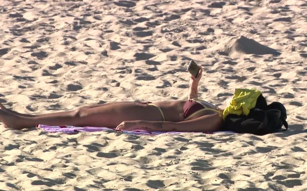 A sunbather in Port Melbourne.