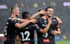 Wellington Phoenix players celebrate a goal from Tim Payne against Perth Glory.