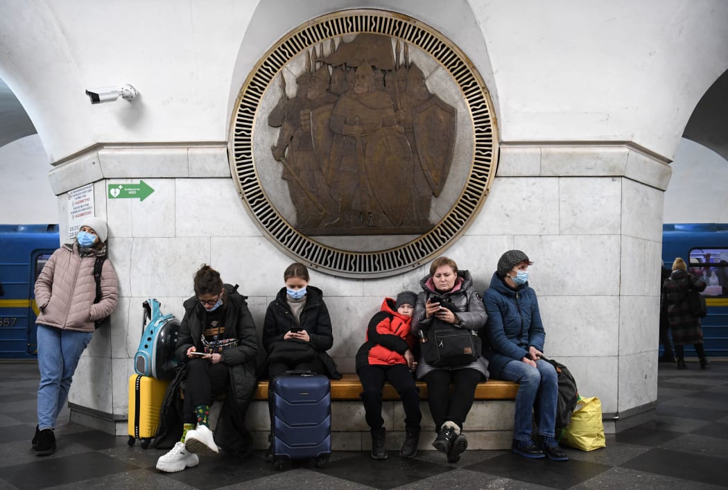 People take shelter in Vokzalna metro station in Kyiv in the morning of February 24, 2022.