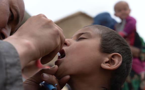A child receives polio vaccination drops after the landslide disaster in Badakhshan, Afghanistan.