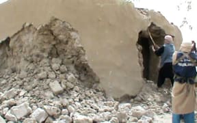 A still from a video shows Islamist militants destroying an ancient shrine in Timbuktu on July 1, 2012