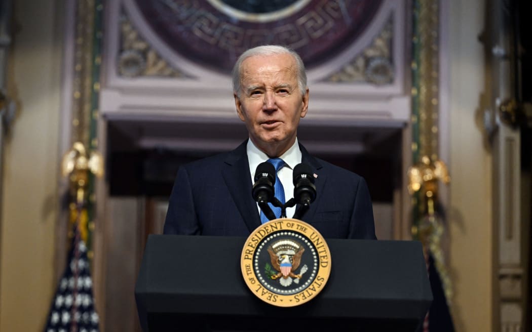 US President Joe Biden speaks at a meeting of the National Infrastructure Advisory Council, in the Indian Treaty Room of the White House in Washington, DC, on December 13, 2023.