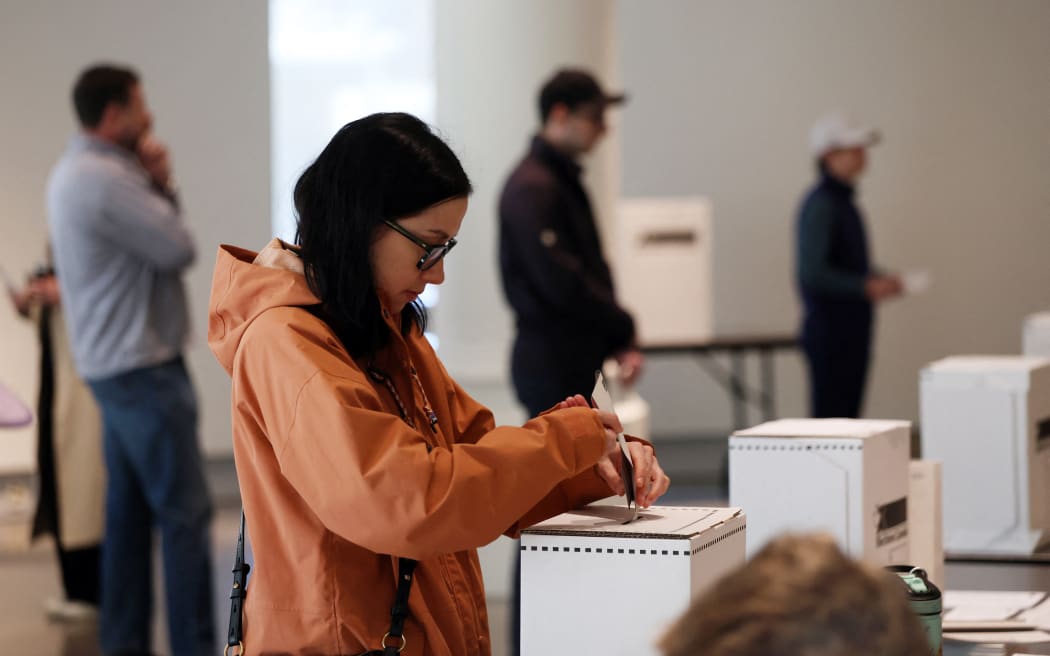 A voter casts her ballot at a polling station on election day, on April 28, 2025 in Ottawa, Canada.