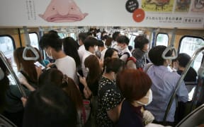 An inside of train is packed with passengers on a JR Line  during a rush hour in Ota Ward, Tokyo  on June 15, 2020,