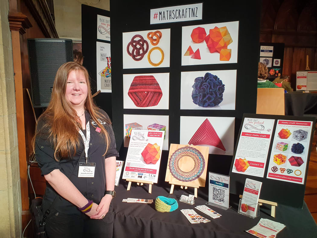 Jeannette McLeod, Maths Craft director, at the festival in Christchurch stands in front of some craft examples.