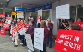 Executive director for the Association of Salaried Medical Specialists, Sarah Dalton, pictured here with loud speaker, says while Finance Minister Nicola Willis has declined to meet striking doctors today, the government needs to hear their message on what under-funding is doing to the public health system.