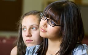 Two girls listening