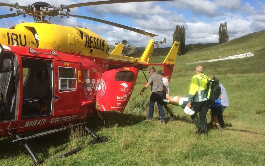 The injured woman is loaded onto the rescue helicopter.