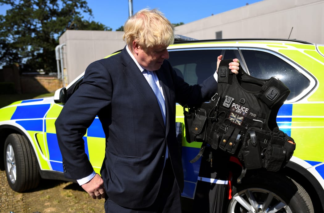 Conservative MP and leadership contender Boris Johnson holds a bulletproof vest during his visit to the Thames Valley Police Training Centre.