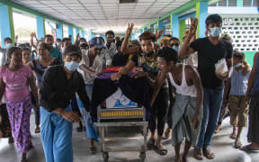 Family members and relatives attend the funeral ceremony of 13 year-old Sai Wai Yan, who was shot dead while playing outside his house in Yangon, Myanmar on March 28, 2021.