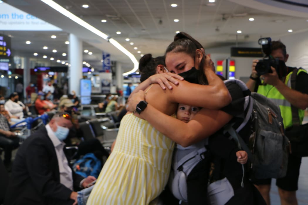 A reunited family at Auckland International Airport today, with a grandmother meeting her grandchild for the first time.