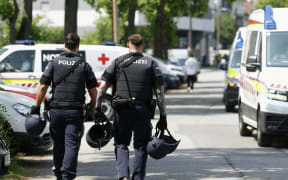 Two policemen at the scene of a school shooting in Graz in southeastern Austria, which has claimed multiple lives.