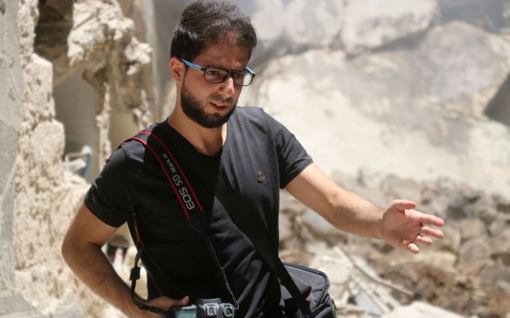A photo taken on June 8, 2016 shows AFP's reporter, photographer and videojournalist in rebel-held Aleppo Karam al-Masri at the site of an air strike next to a hospital in the al-Shaer neighbourhood of the northern Syrian city.