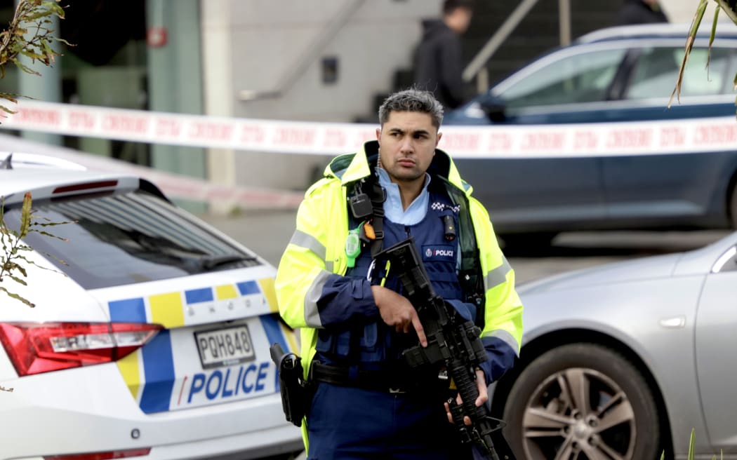 Armed police remain at the cordon of a serious shooting incident in downtown Auckland on 20 July, 2023.