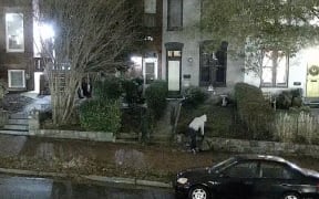 This still from video from the FBI shows the person who placed two viable pipe bombs near the Republican and Democratic National Committee headquarters in Washington, DC in January 2021.