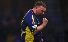 England's Luke Littler celebrates winning the fourth set against Netherlands' Michael van Gerwen during the PDC World Darts Championship final, at Alexandra Palace in London on January 3, 2025. (Photo by Ben STANSALL / AFP)