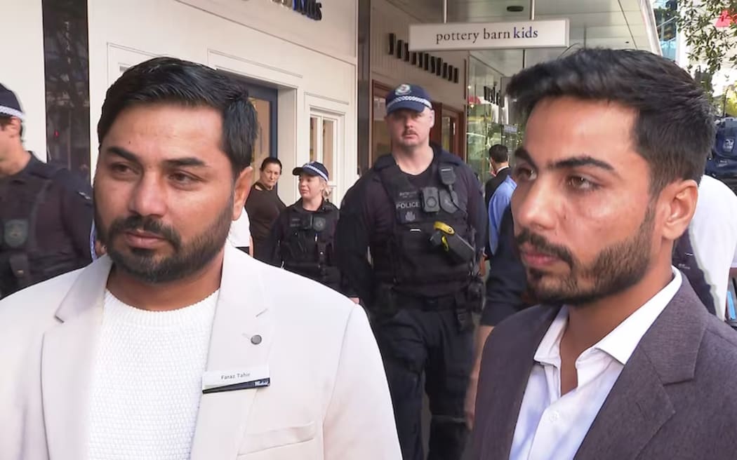 Two brothers of killed security guard Faraz Tahir attended the commemoration wearing their brother's name tag.