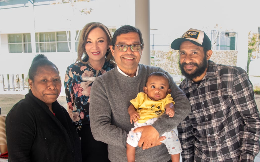 Dr Gordon Thomas with Sawong and his parents.