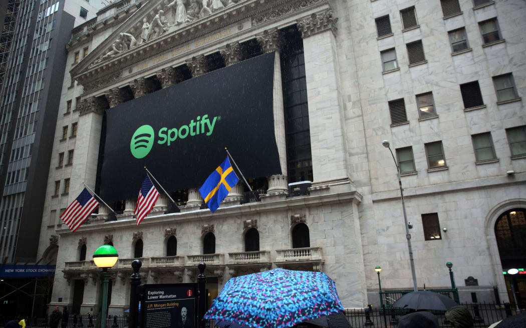 A banner with the Spotify logo on it is seen as the company lists its stock on the New York Stock Exchange in New York, United States on April 3, 2018.