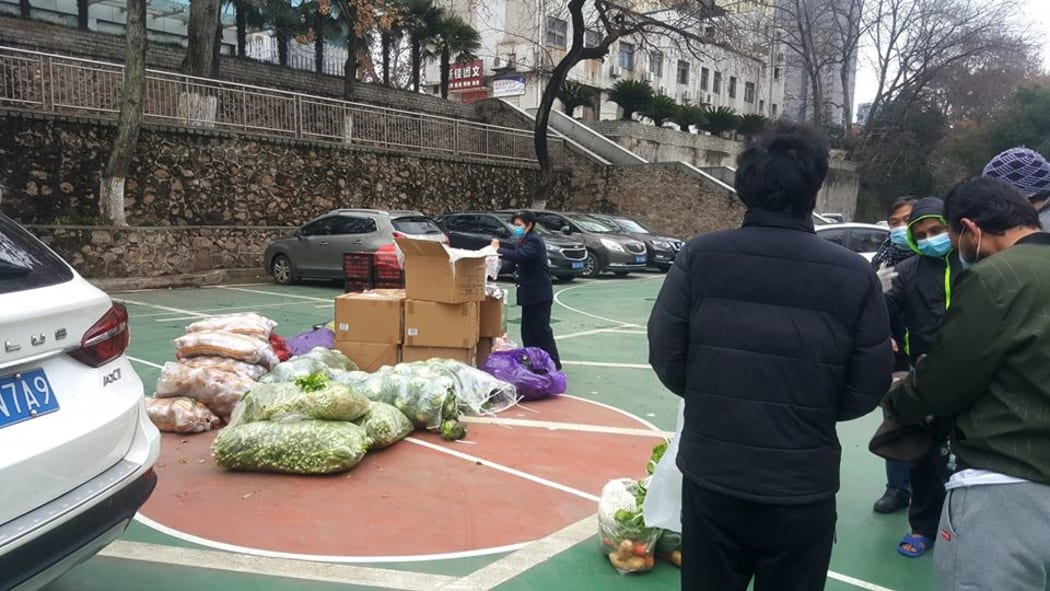Members of the International Students Office at Wuhan University of Technology provide vegetables to students who have remained on campus.