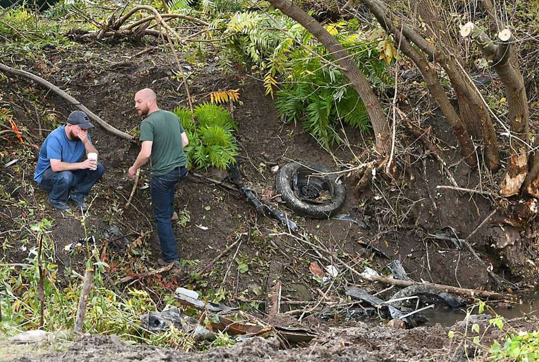 Distraught family members take in the scene, one day after an accident that left 20 people dead in New York state.
