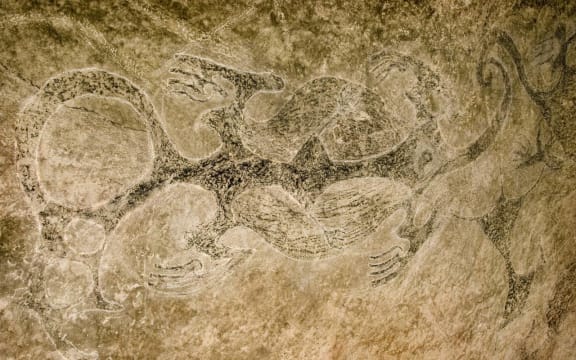 Ngāi Tahu rock art of three taniwha with their tails intertwined.