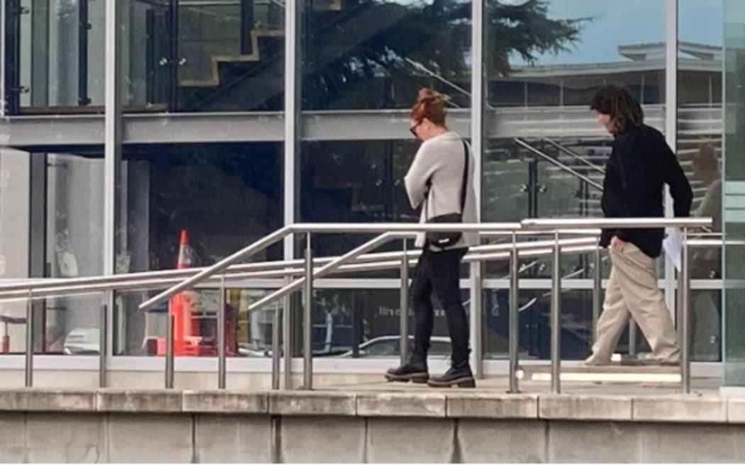 Jordan Turner-Critchley behind a supporter as they left the Nelson District Court. Photo / Tracy Neal