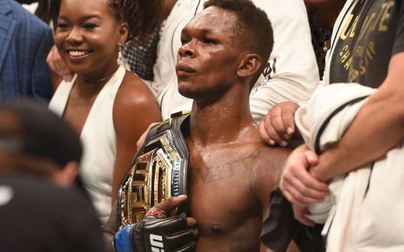 Israel Adesanya reacts after winning the UFC interim MW title belt a bout against Kelvin Gastelum.