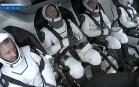 Nasa and private rocket company SpaceX launched four astronauts into orbit