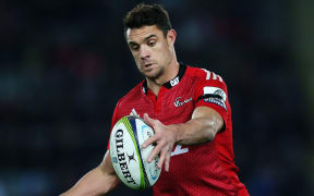 The Crusaders first-five Dan Carter kicks the ball.