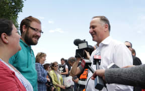 John Key talks to tourists waiting to leave