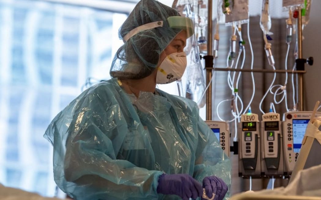 This image released by Northwestern Medicine, shows nurses at the Covid-19 Intensive Care Unit of Northwestern Memorial Hospital in Chicago. -