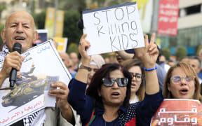 People shout slogans as they hold a protest in support of Palestinians in Gaza, in the city of Nablus in the occupied West Bank on October 19, 2023. Thousands rallied across the Arab and Muslim world on October 18 to protest the deaths of hundreds of people in a strike on a Gaza hospital that they blame on Israel, despite its denials. (Photo by Zain JAAFAR / AFP)