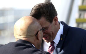 New Zealand Defence Minister Ron Mark receives US Secretary of Defense Mark Esper (R) at Auckland International airport on August 5, 2019. - Esper is in New Zealand for two days to hold bilateral meetings.
